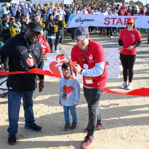 Heart-Walk-2024-Larry-Seth-and-son-cut ribbon