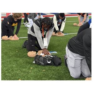 Practicing Hands-Only CPR at Senior Bowl CPR training event