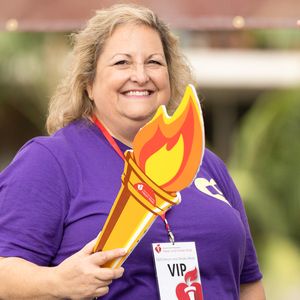 Luise Brandy holding the torch at the San Diego Heart & Stroke Walk