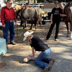 Beach Ride participant practices Hands-Only CPR 