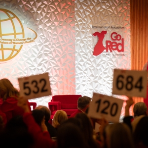  Guests hold bid paddles at Dallas' Go Red for Women movement 