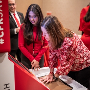  Women take turns using Hands-Only CPR kiosk to learn a lifesaving skill