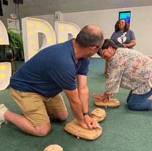 Participant Practicing Hands Only CPR Compressions