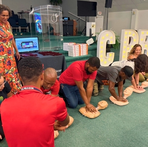 Participants doing hands-only CPR compressions at Charleston - Heroes Saving Hearts