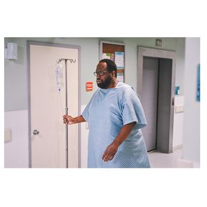 Man with IV pole in hospital