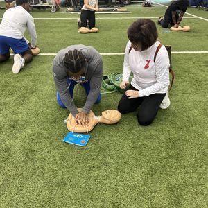 Duke University football players practicing CPR