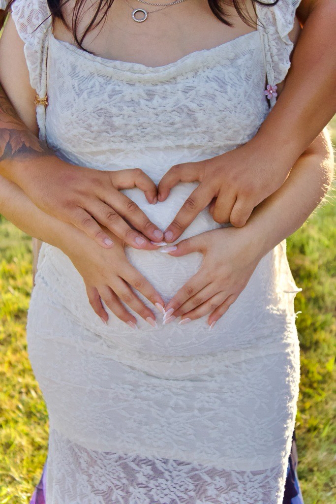 Parents cradle baby bump