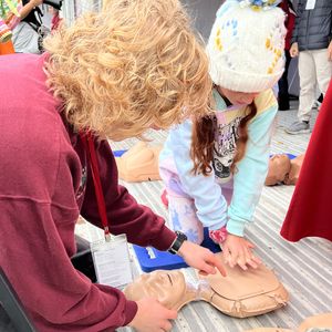 Lucy practices chest compressions at 2025 Washington Heart and Stroke Walk