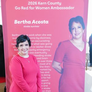 Bertha Acosta poses with her sign in the gallery