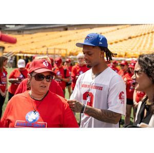 Damar Hamlin signs autographis at Nation of Lifesavers event at NFL Draft.