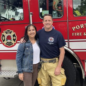 Aaron Gagnon and his wife Angela in front of his firetruck.