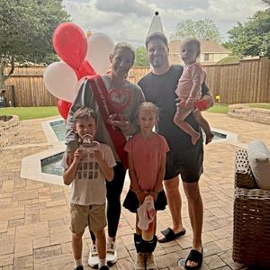 Christina Reed poses with her family and Woman of Impact award in Dallas